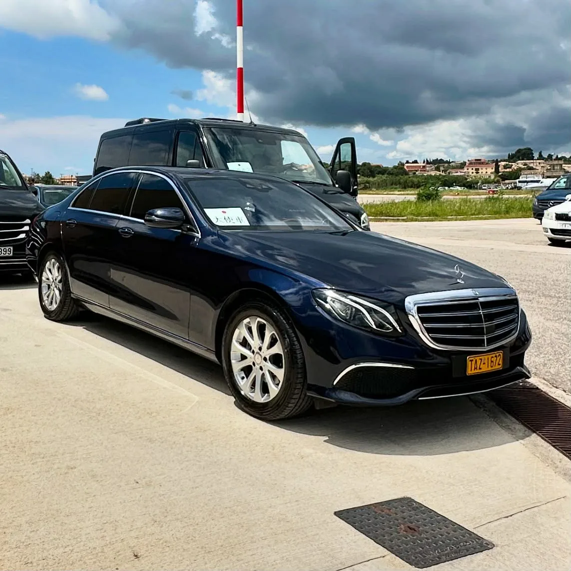 A Mercedes E-Class waiting at the pick-up bay at Corfu Airport